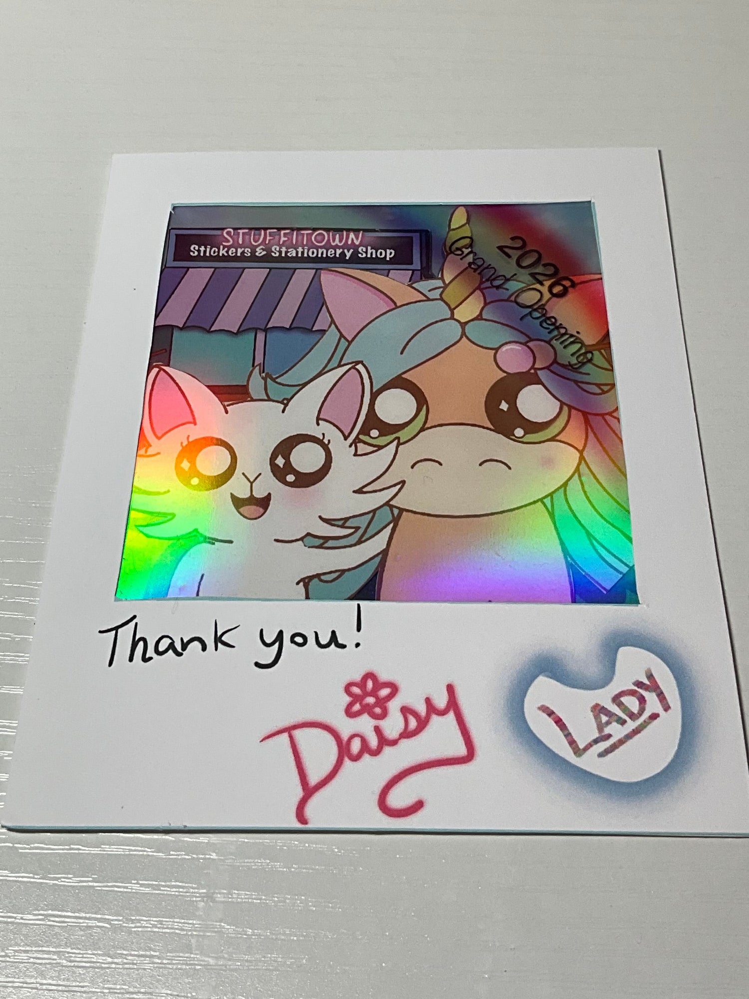 Colorful picture with a white cartoon cat and a peach unicorn.